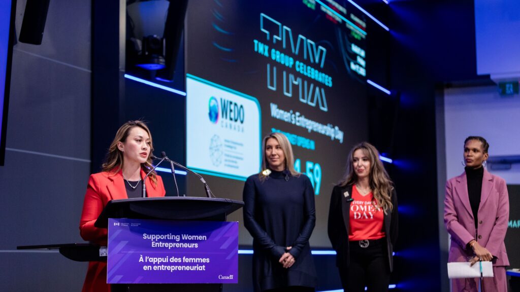 Minister Rechie Valdez speaks at a podium during the Market Open Ceremony at the Toronto Stock Exchange.